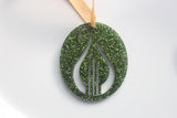 Green glittery ornament with lyre cut out design